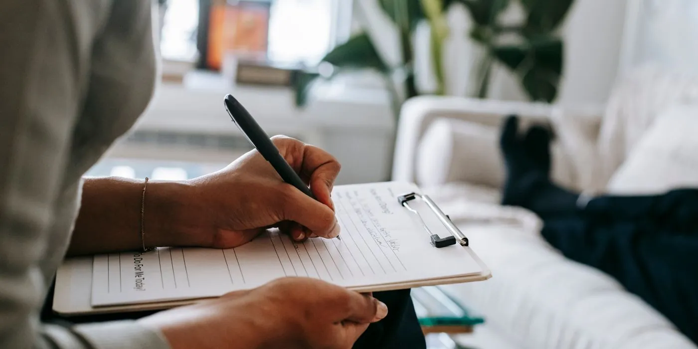 A real hand writing a priority list